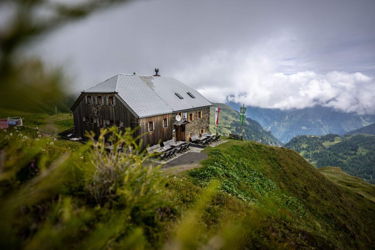 Öffis nutzen - gratis übernachten | © DAV/Wolfgang Ehn Berghütte mit Ausblick ins Tal und aufziehenden Wolken | © DAV/Wolfgang Ehn